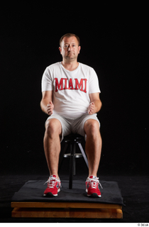 Louis  2 dressed grey shorts red sneakers sitting sports…